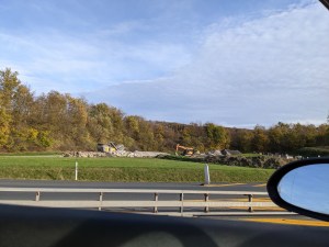 Blick aus dem Autofenster auf Bagger, die an einer Auffahrt der Autobahn stehen, auf der gerade (nicht) gearbeitet wird.